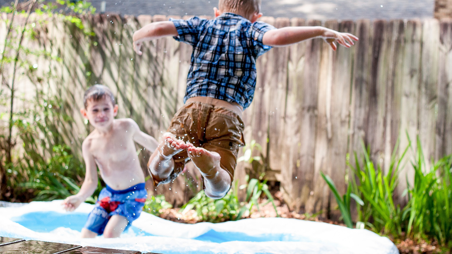 motherhood unfiltered wet kid with clothes on jumping into small pool