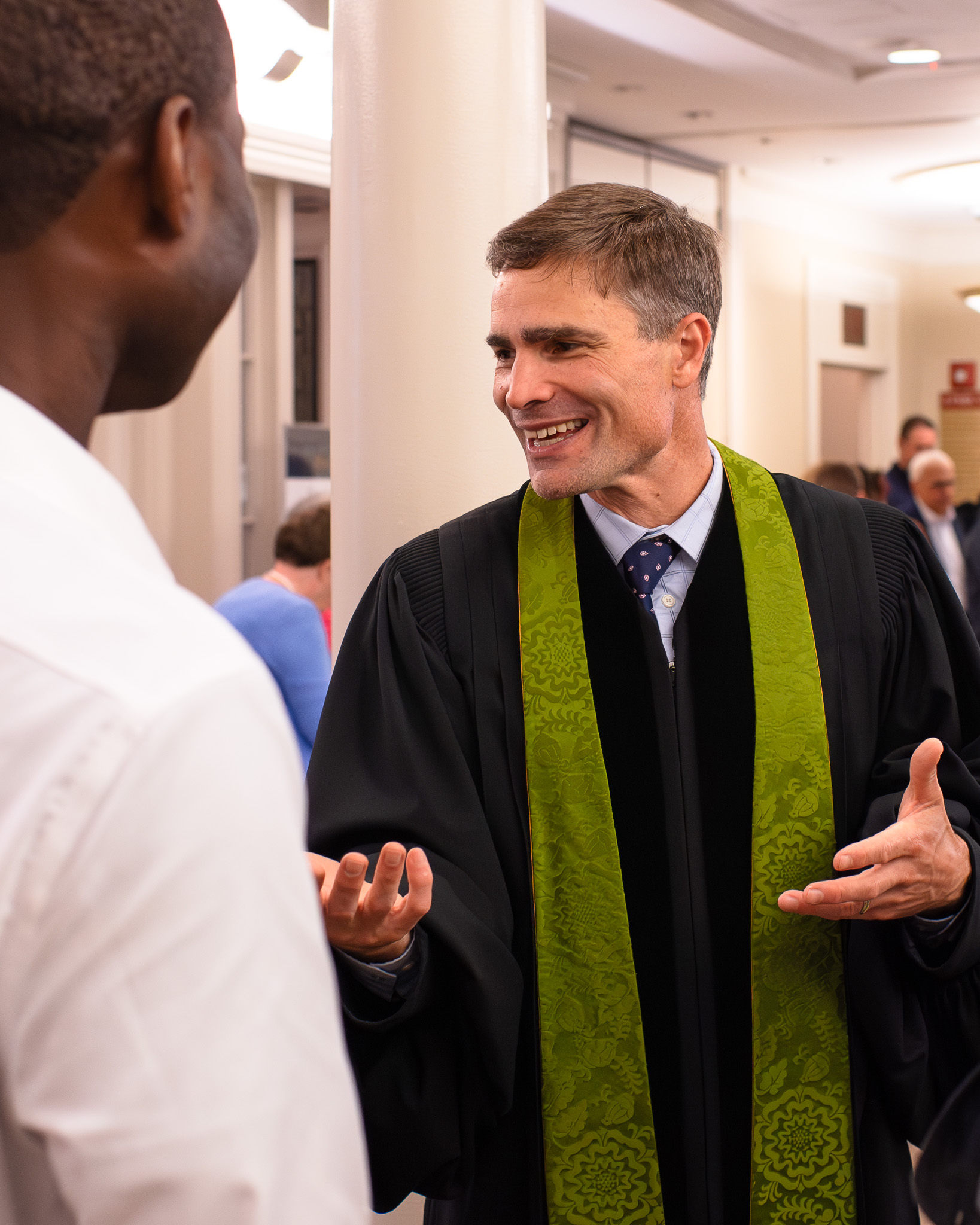Mark Booker speaking with congregants in the welcome center.